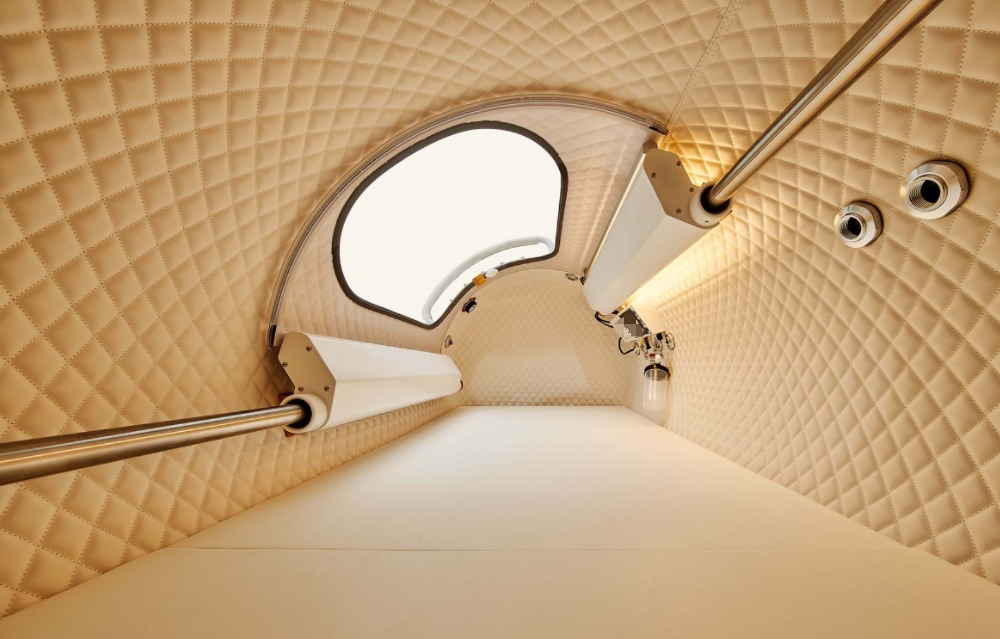 Actual Synergy quilted interior with warm lighting and padded lie-down surface